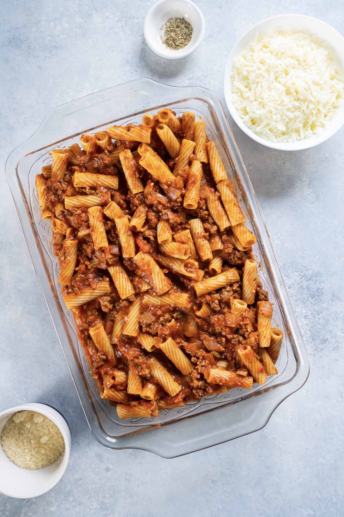 Rigatoni with meat sauce in baking dish.