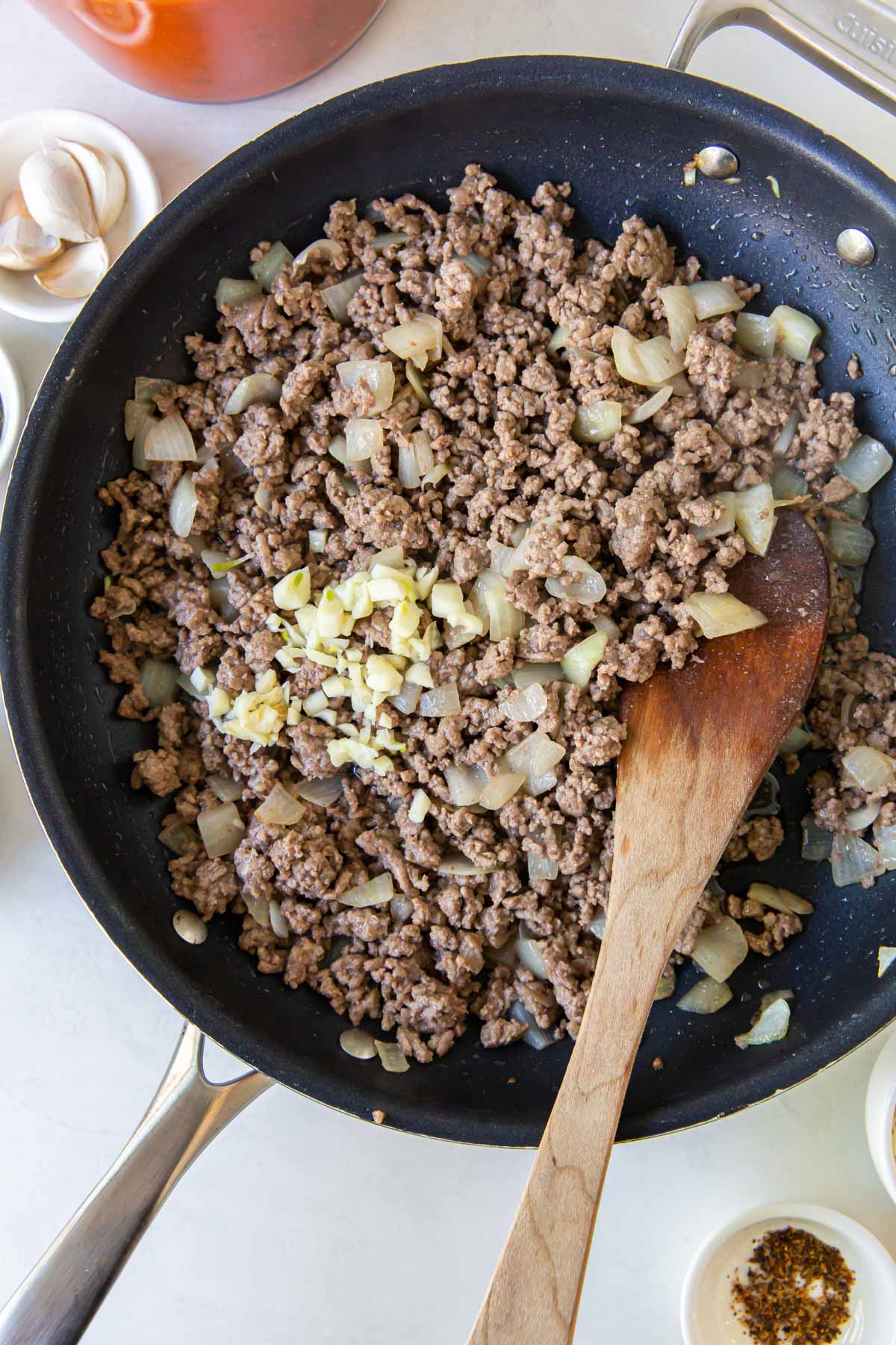 Browned ground beef and onion in skillet.