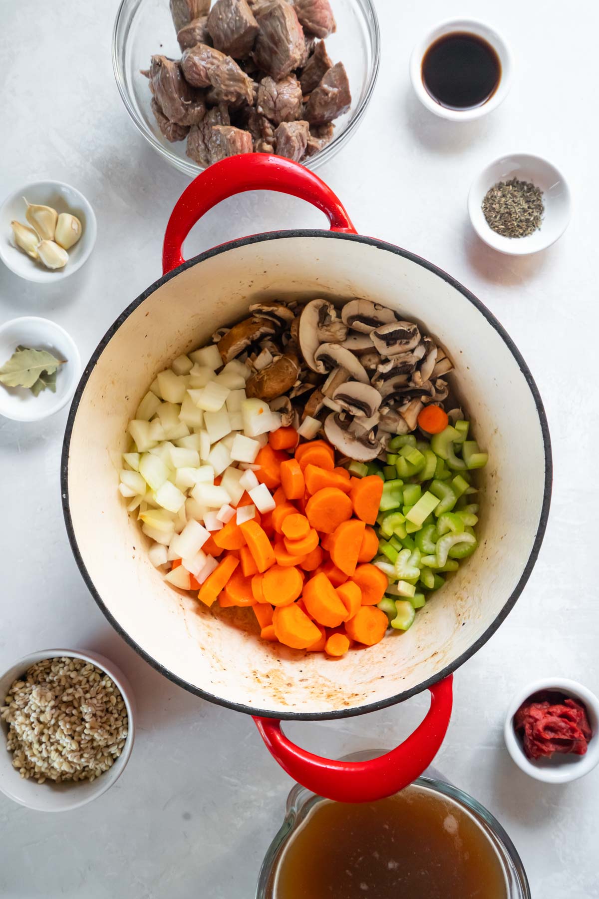 Chopped onion, mushrooms, celery and carrots in pot.