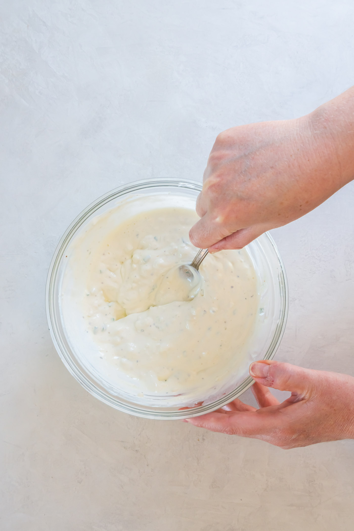 Using back of spoon to mash some of the blue cheese crumbles in the dressing.