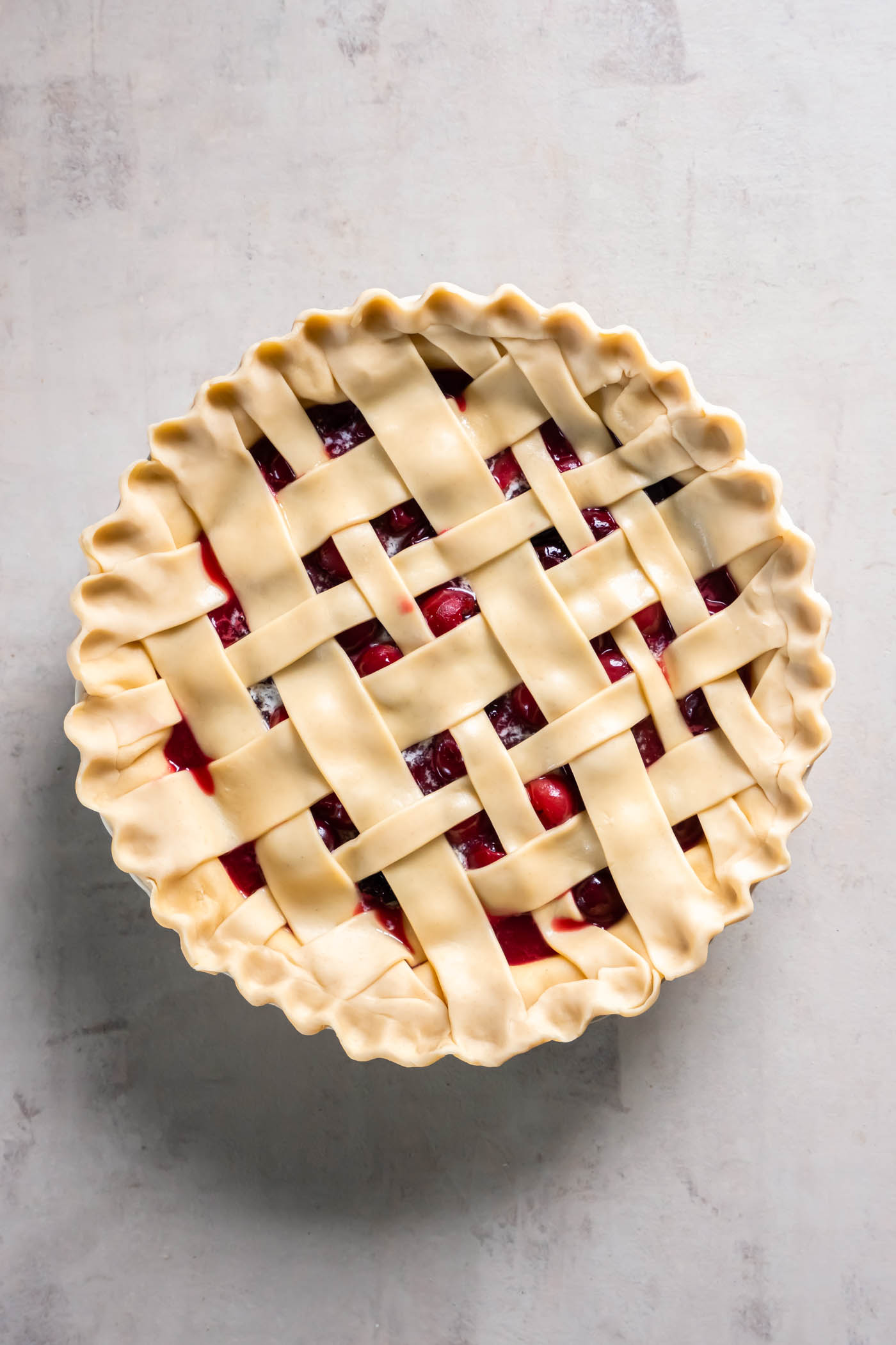 Unbaked cherry pie with lattice crust.