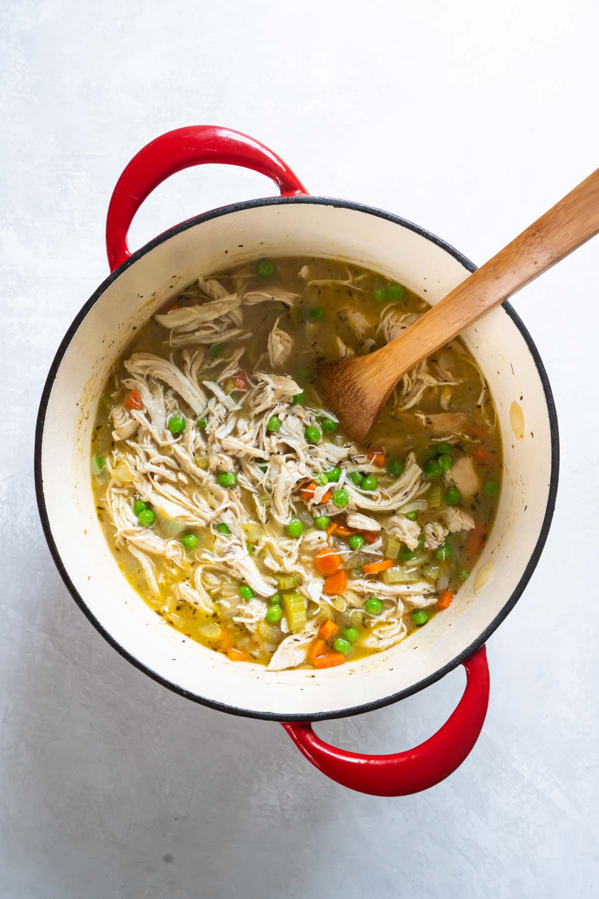 Shredded chicken and frozen peas stirred into soup.