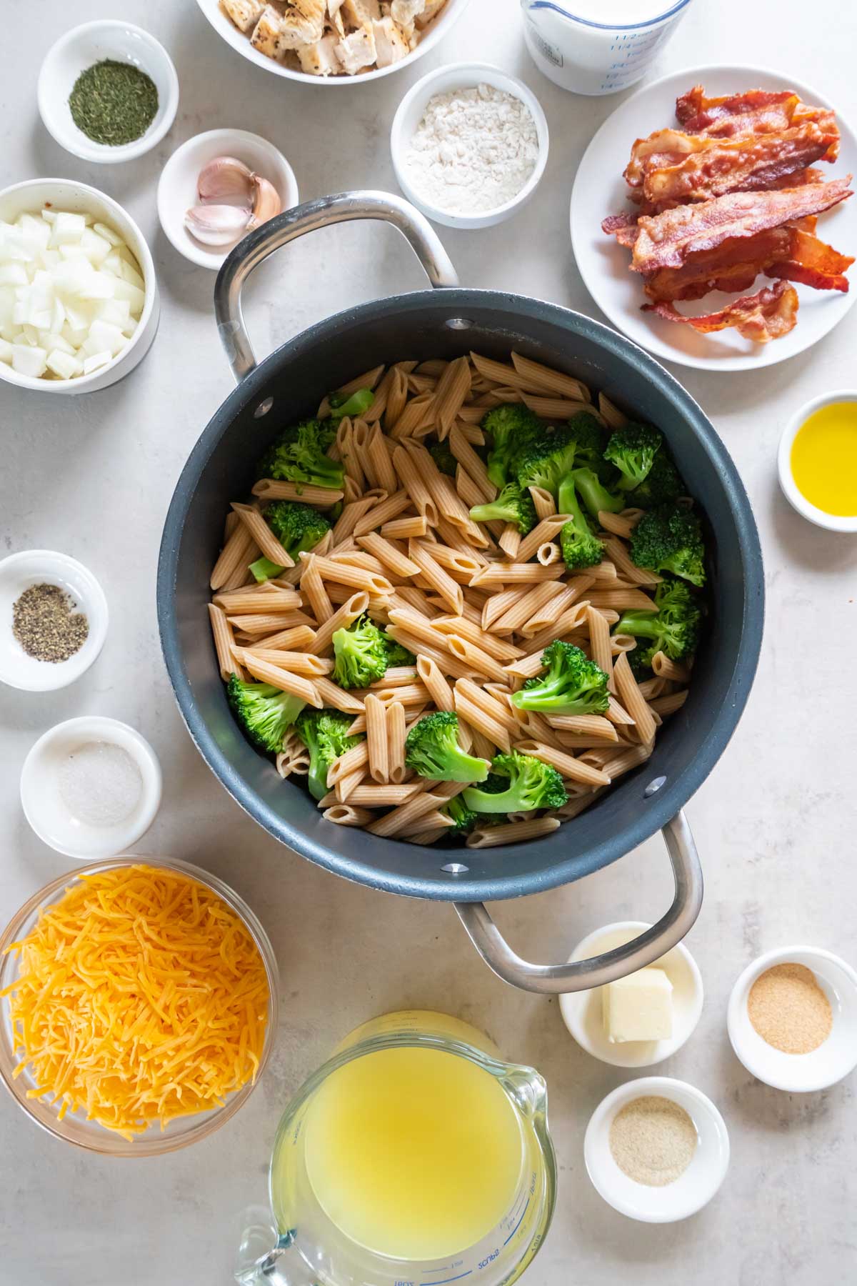 Cooked whole wheat penne and broccoli in pot.