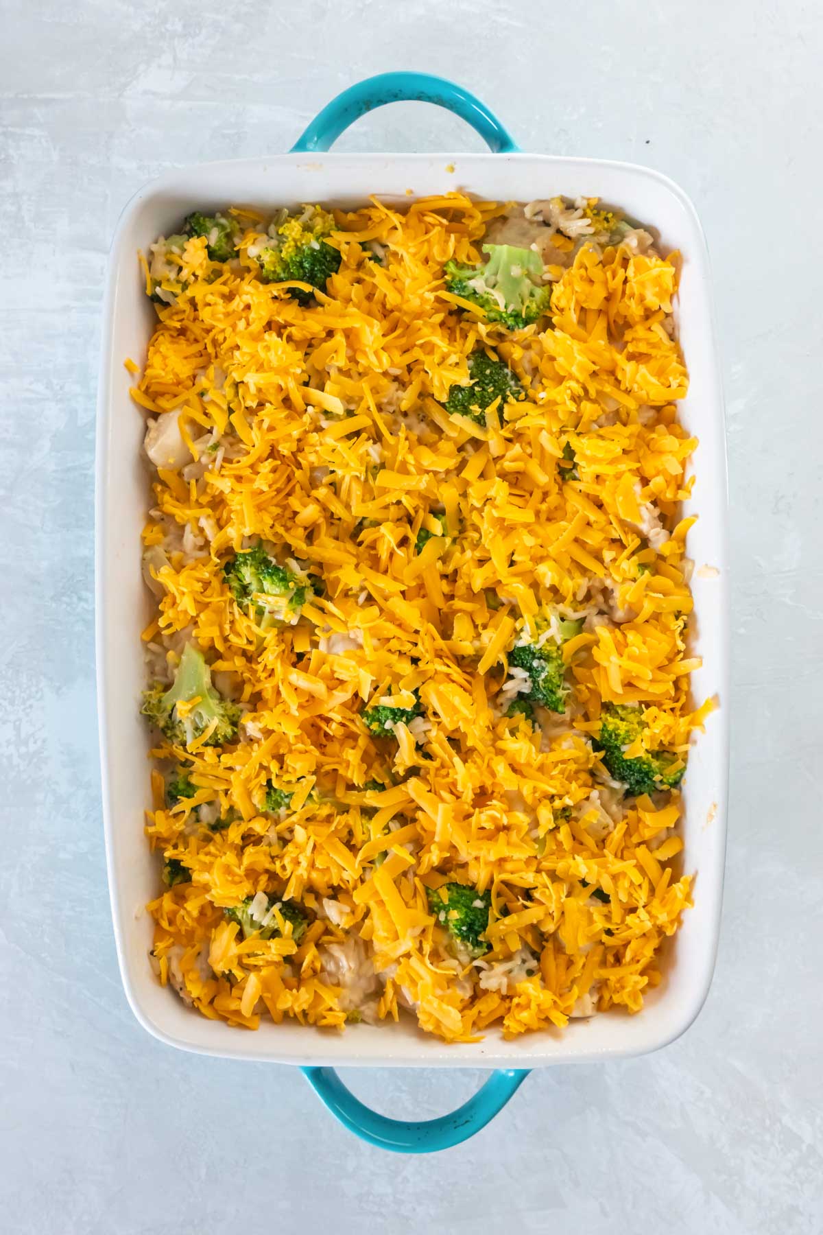 Unbaked chicken broccoli rice casserole in baking dish.