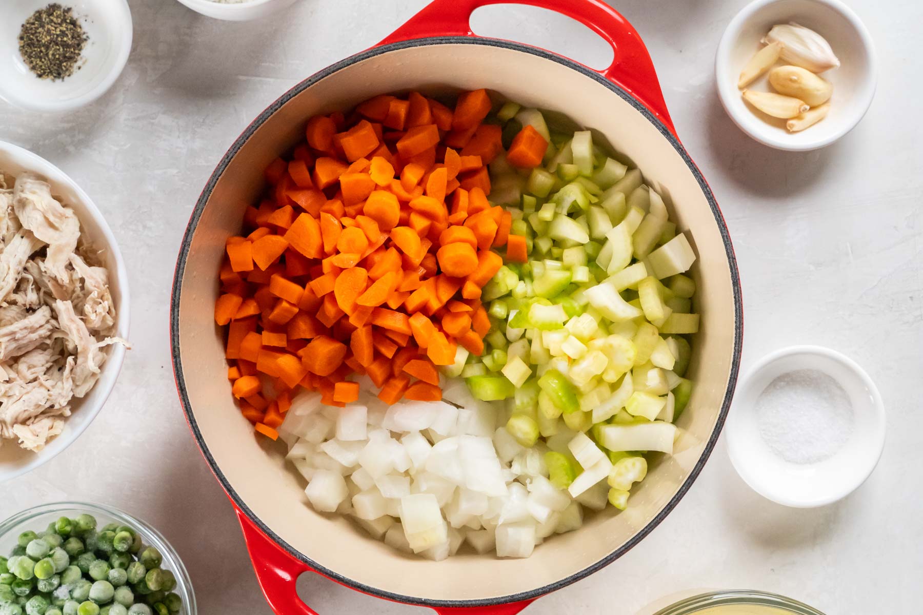 Chopped onion, carrots and celery in dutch oven pot.