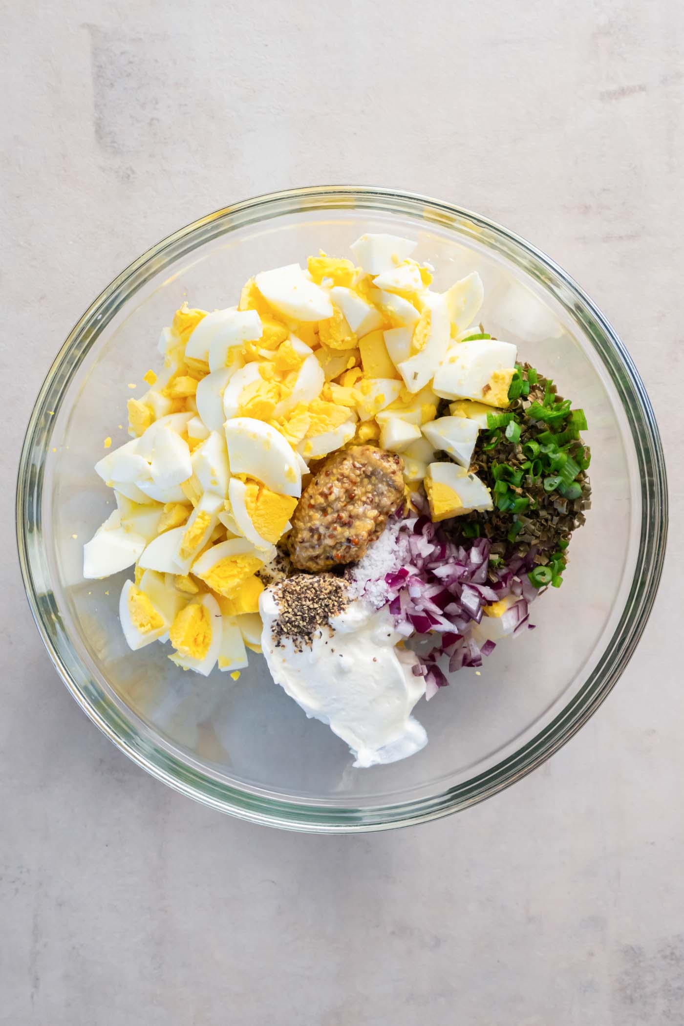 Egg salad ingredients in a mixing bowl.