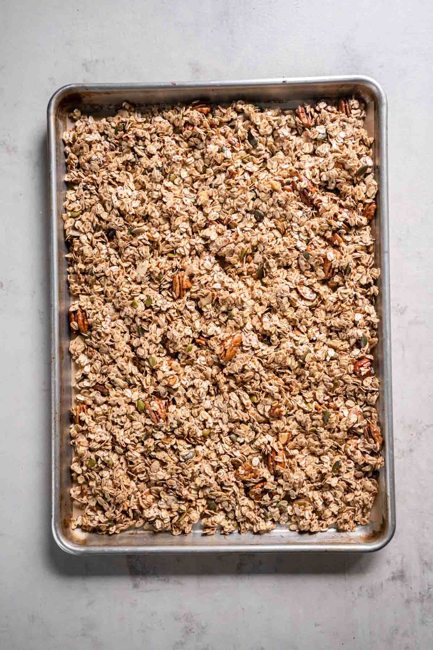 Unbaked granola on baking sheet.