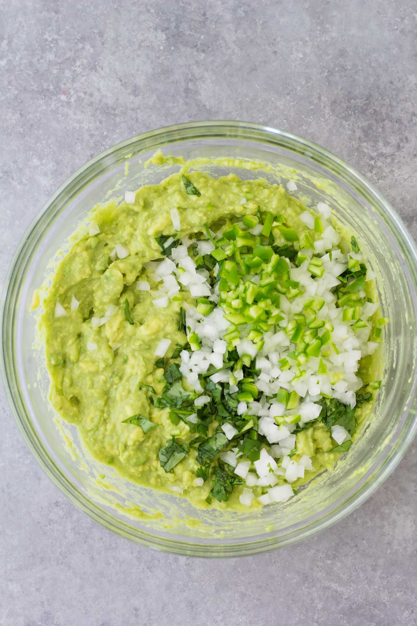 Guacamole ingredients in a mixing bowl.