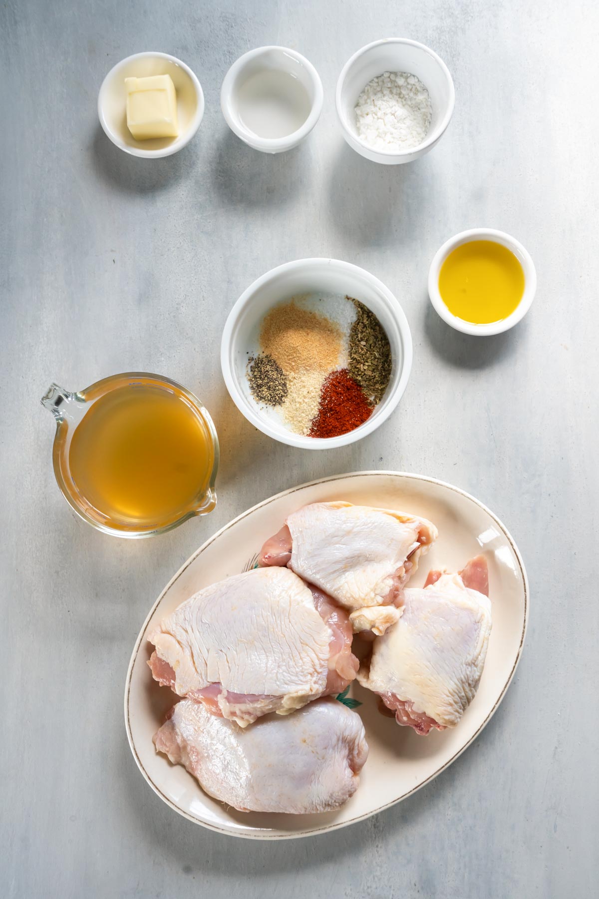 Seasonings combined in a ramekin with other recipe ingredients around the dish.