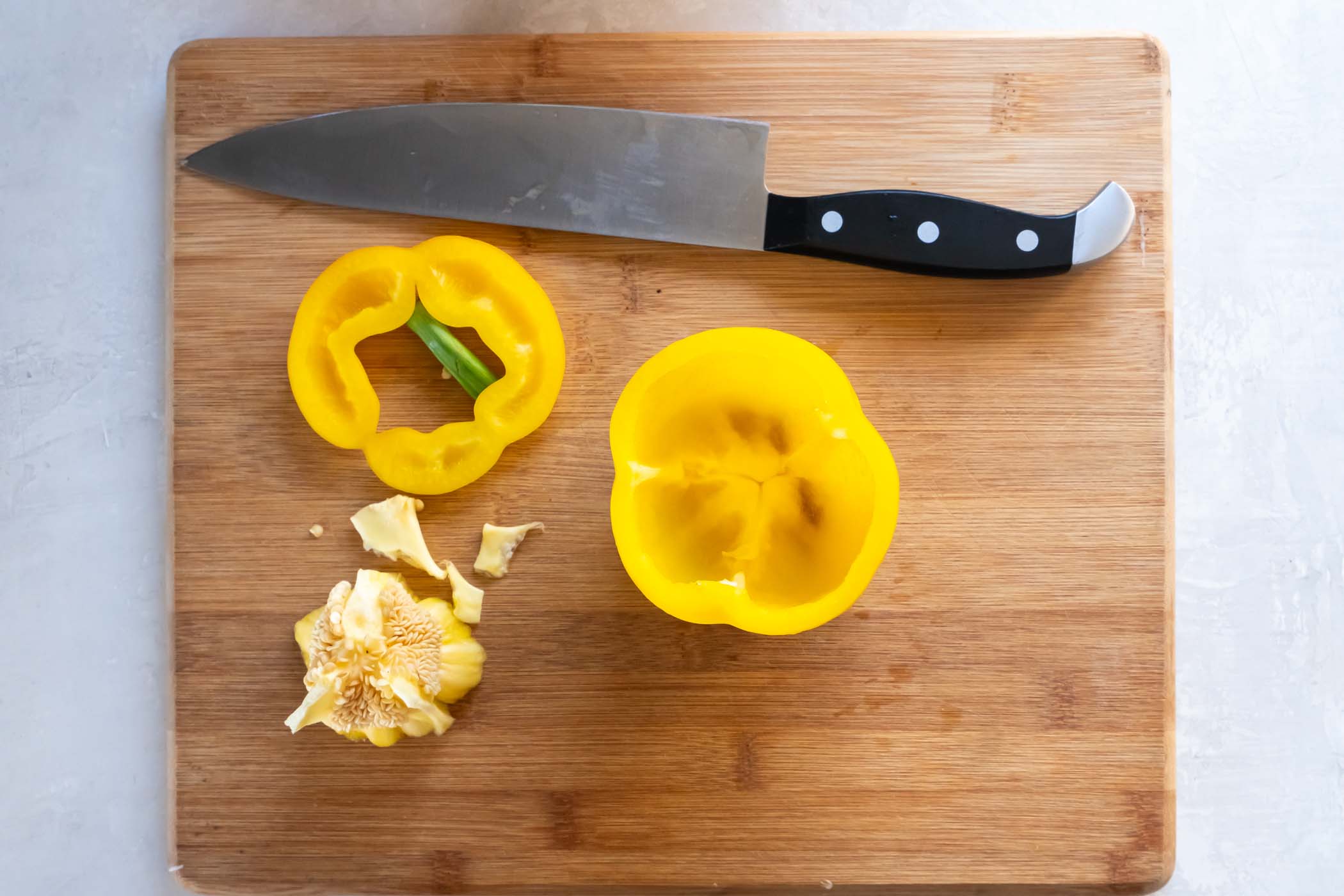Yellow bell pepper with top sliced off and seeds removed.