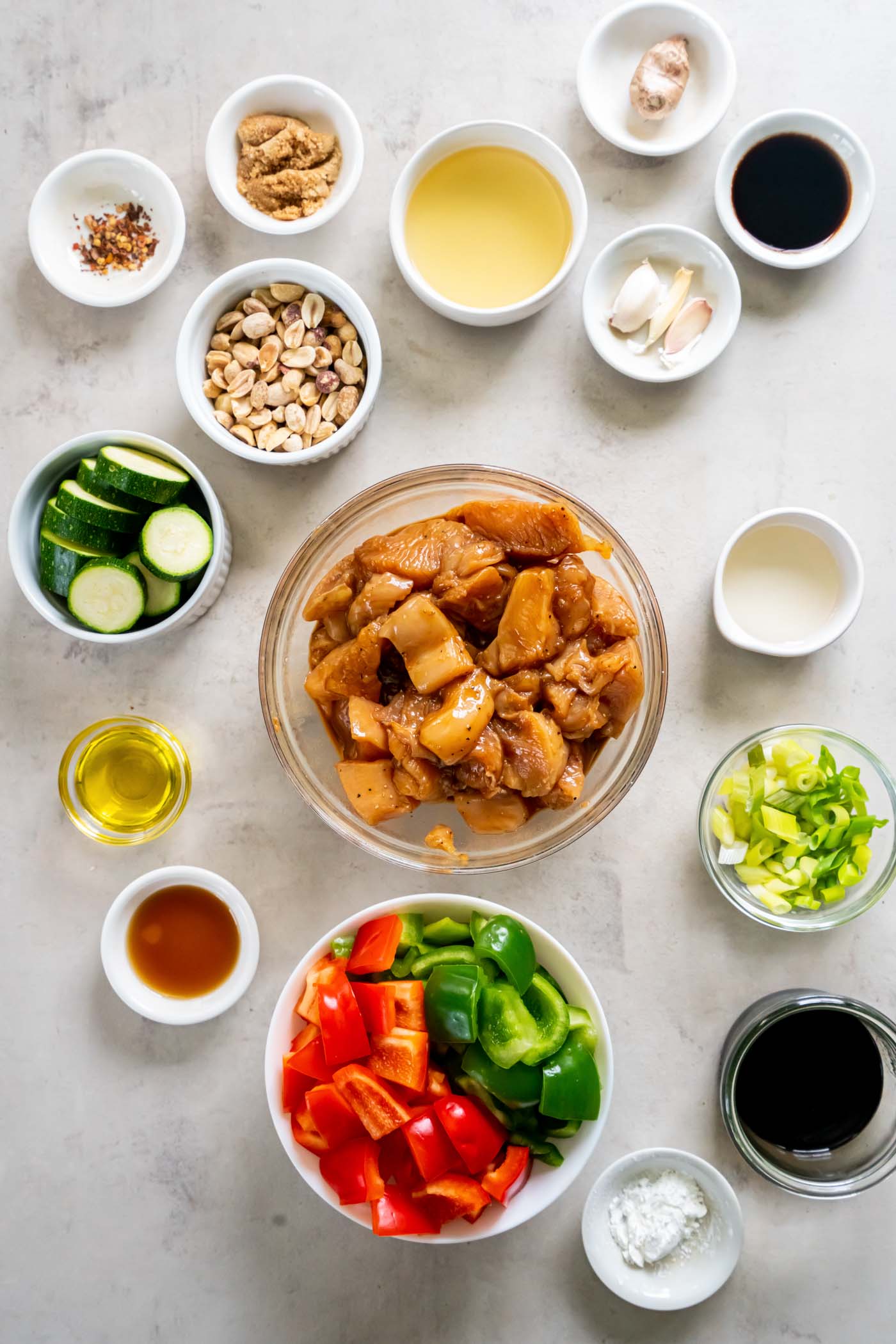 Chicken pieces tossed with marinade in bowl.