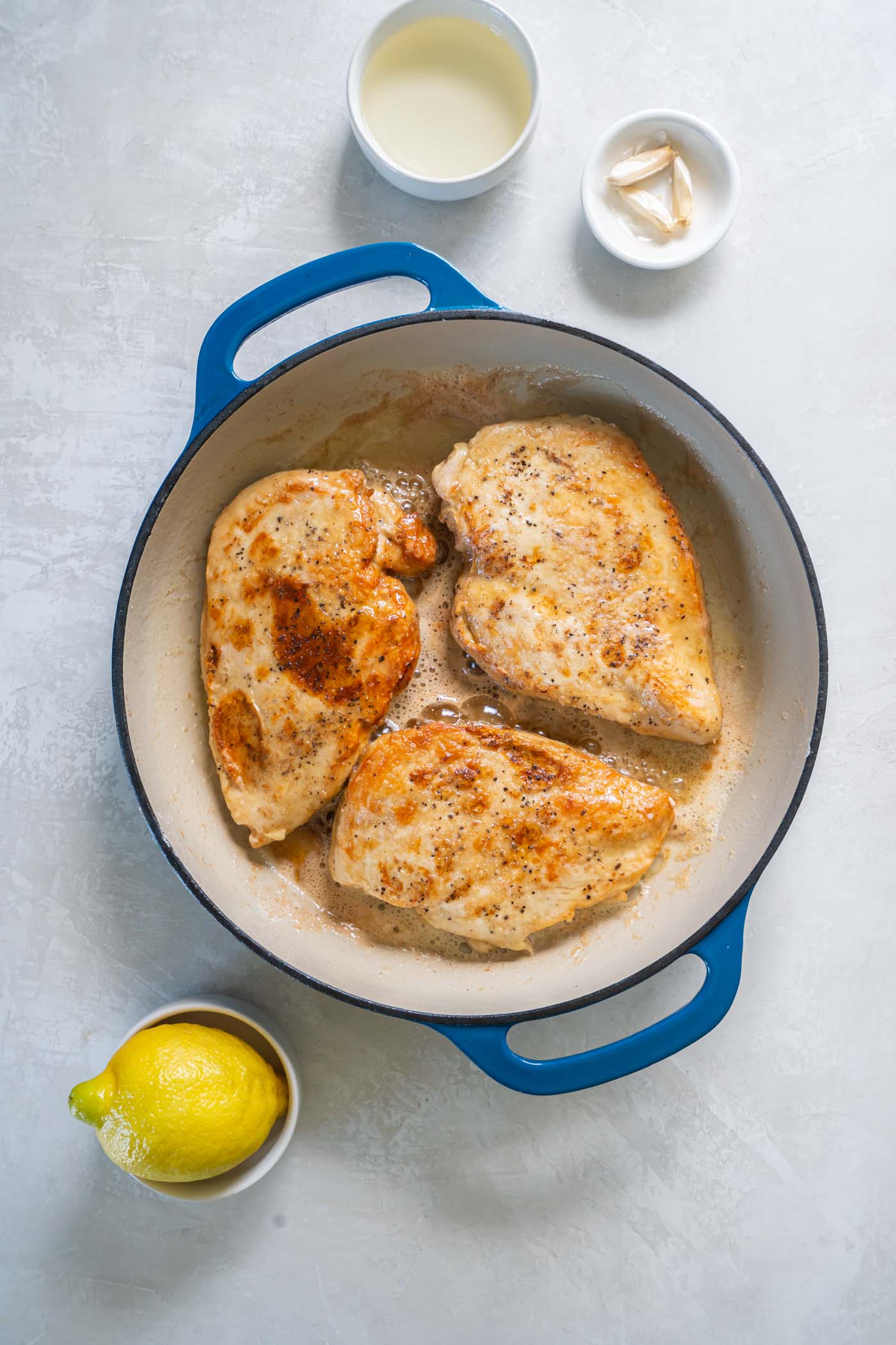 Browning chicken breasts in pan.