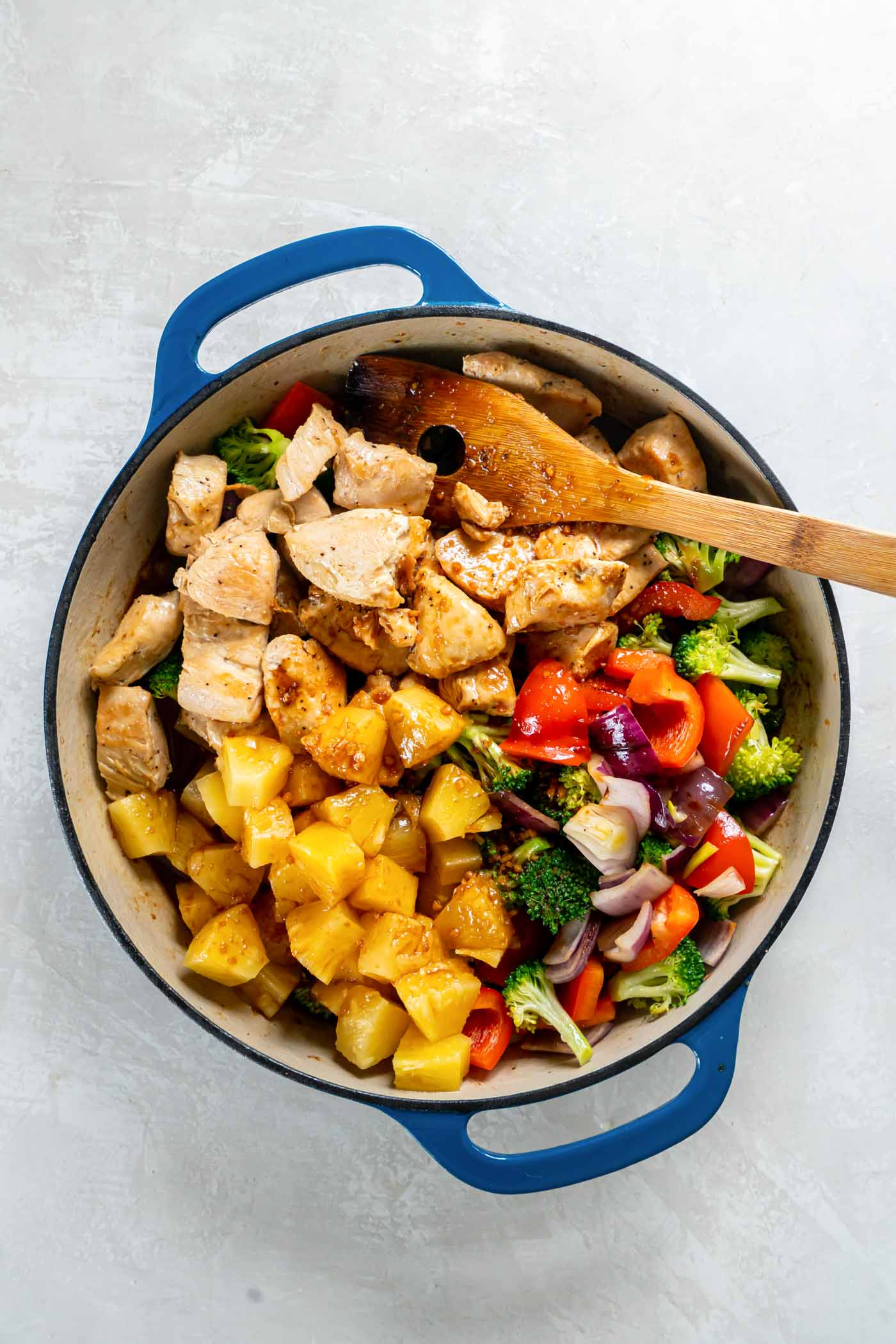 Chicken, pineapple and teriyaki sauce added to pan with vegetables.