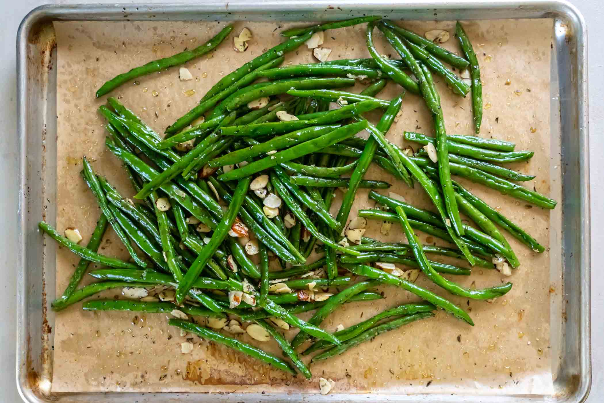 Partially baked green beans tossed with sliced almonds and garlic.