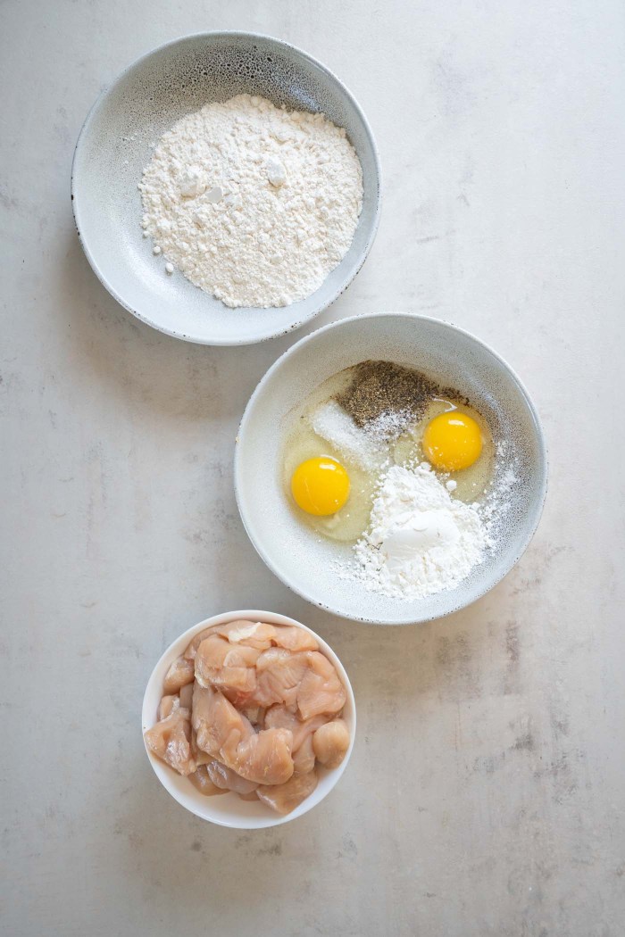 Flour in one dish; eggs, cornstarch, salt and pepper in another dish; chicken in a bowl.