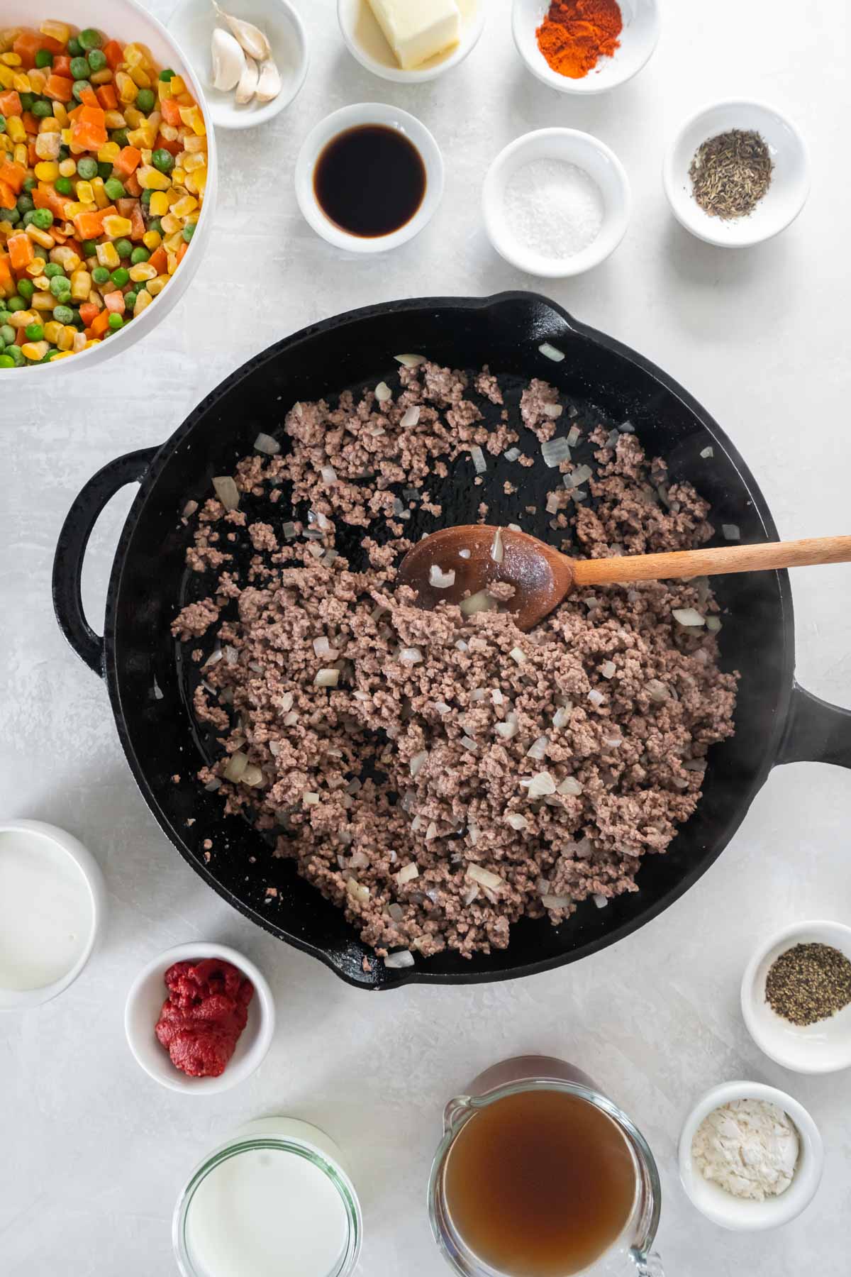 Browned ground beef and onion in a cast iron skillet.
