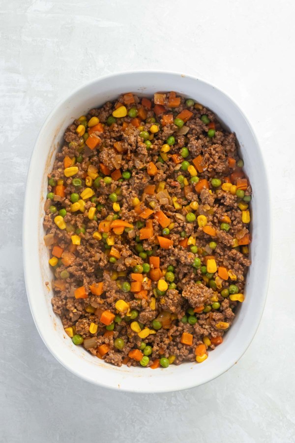 Beef and vegetable filling in casserole dish.