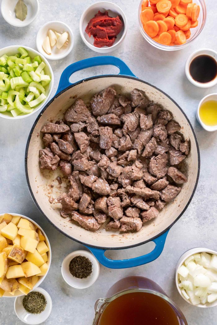 Browned beef cubes in a skillet.