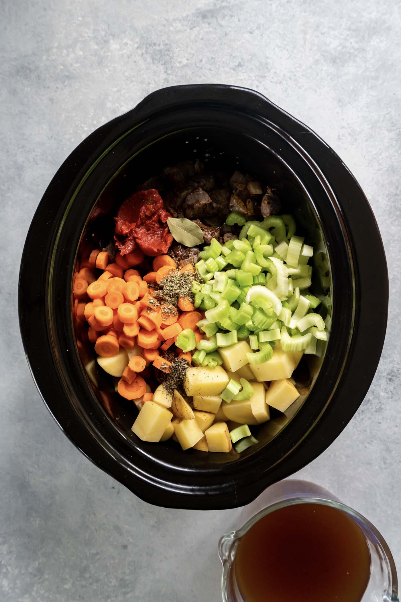 Beef, onions, carrots, potatoes, celery, tomato paste and seasonings in slow cooker.