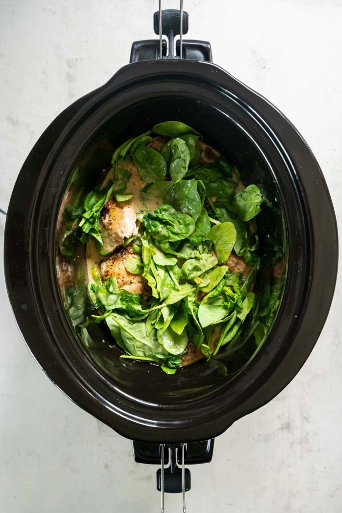 Fresh spinach added to slow cooker.