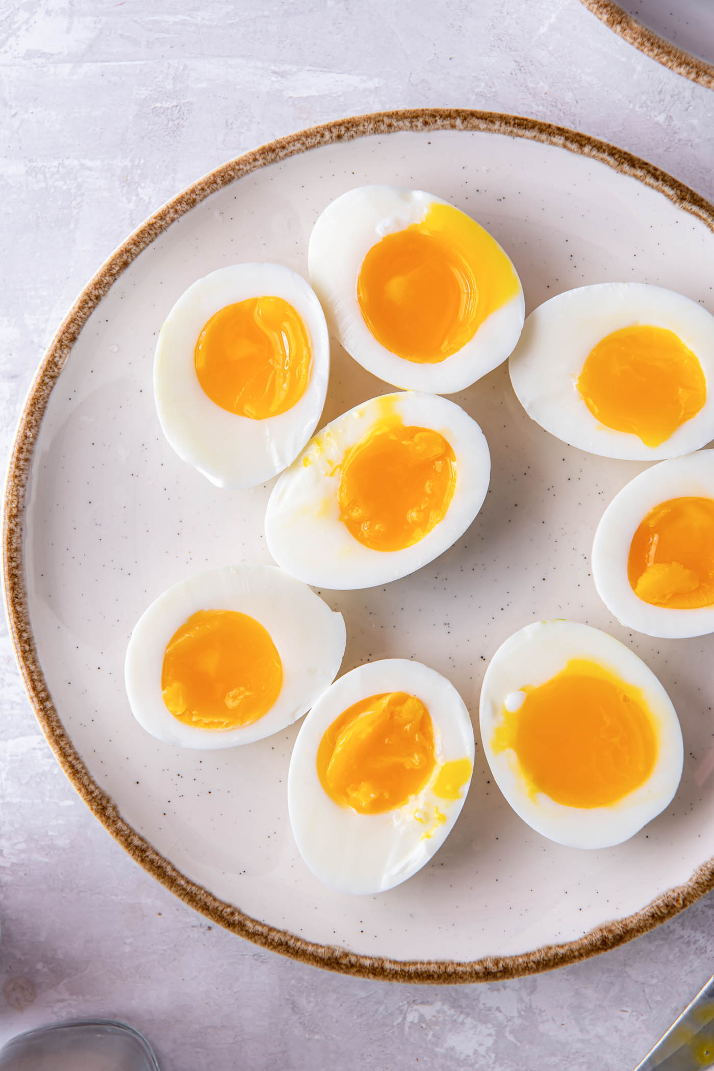 Soft boiled eggs cut in half on a plate.