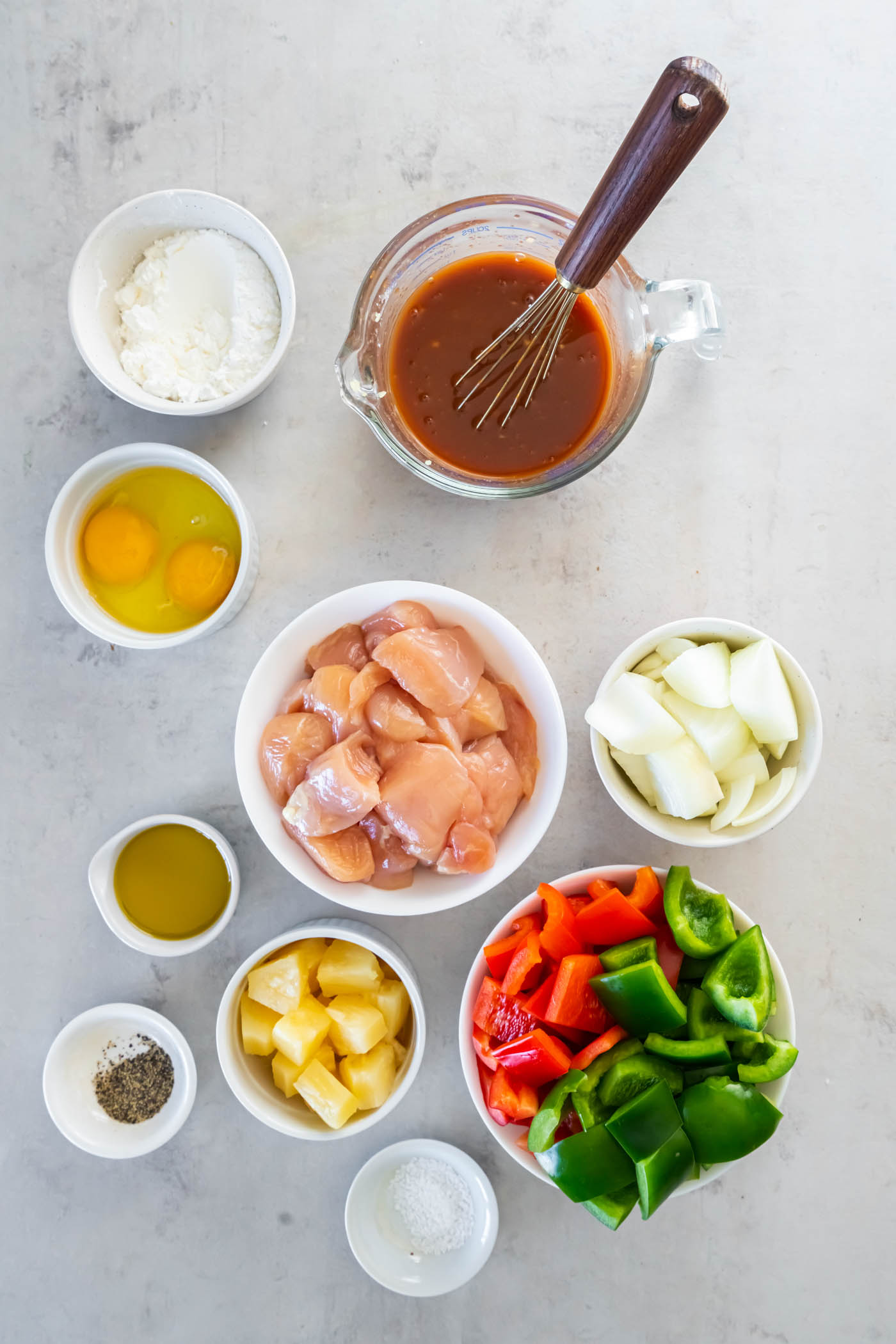Sweet and sour chicken ingredients with sauce whisked together.