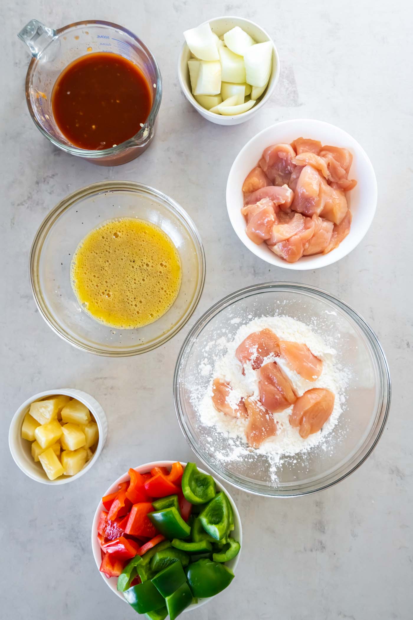 Coating chicken pieces in cornstarch.