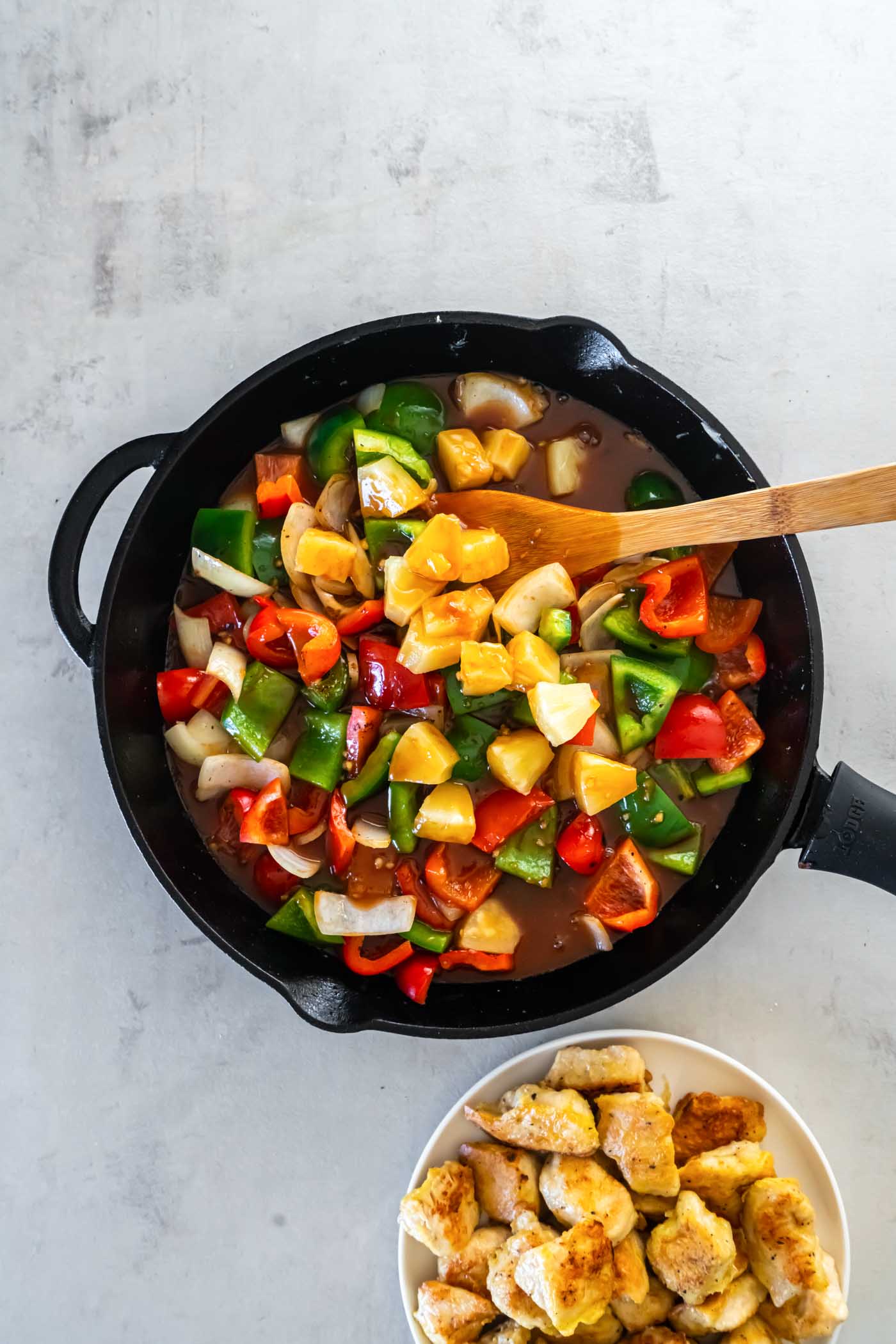 Sweet and sour sauce and pineapple added to skillet.