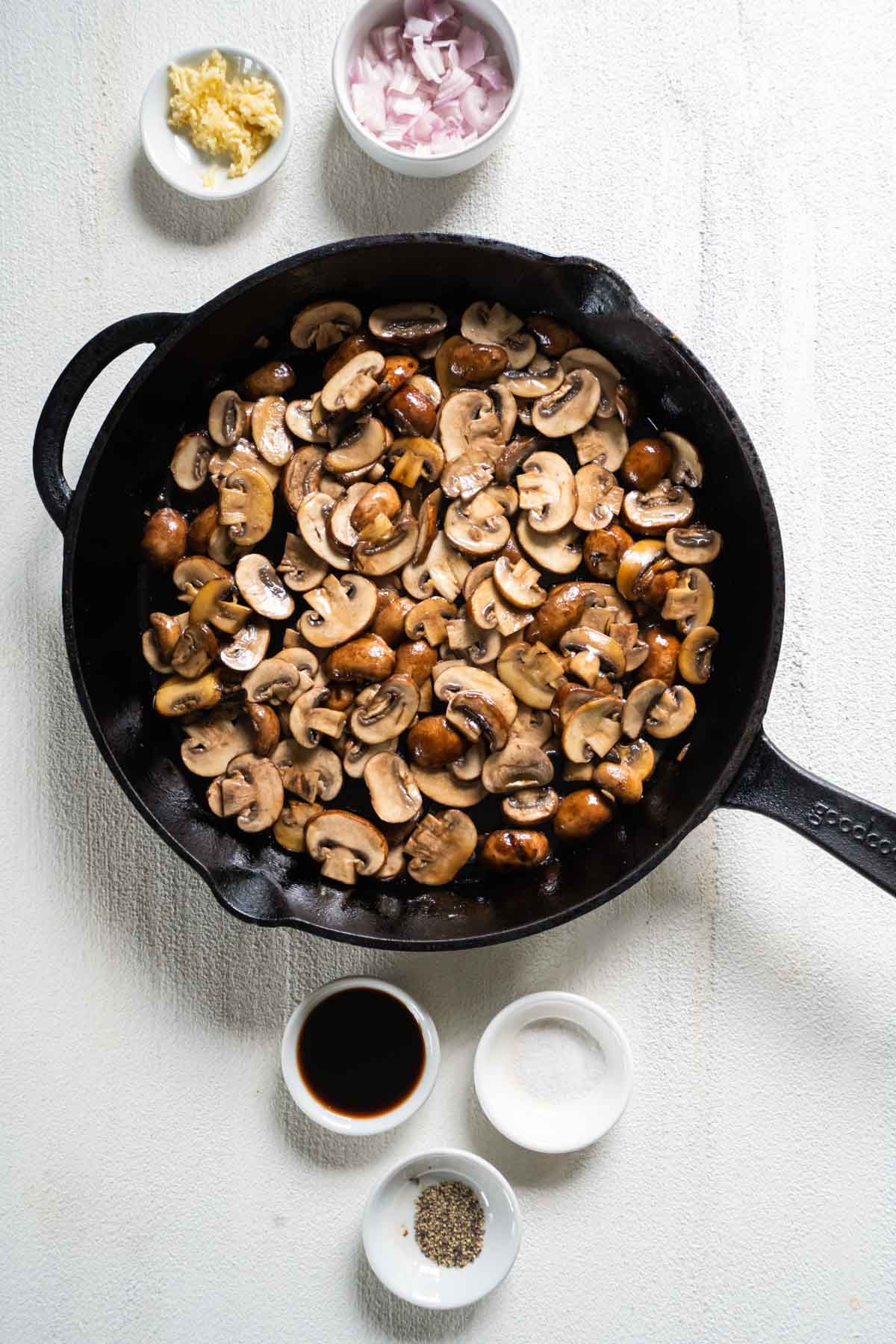 Browned mushrooms in cast iron skillet.