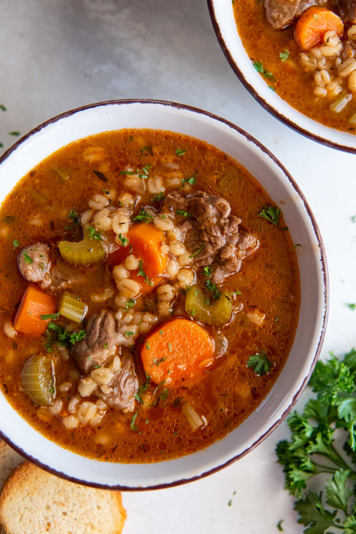Bowl of instant pot beef barley soup.