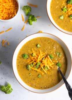Instant Pot broccoli cheddar soup in a bowl with a spoon.