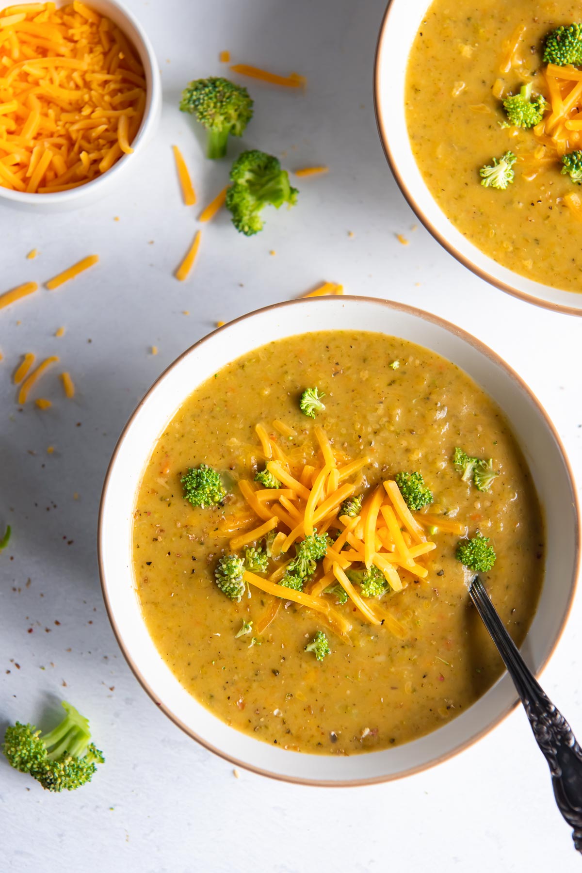 Instant Pot broccoli cheddar soup in a bowl with a spoon.