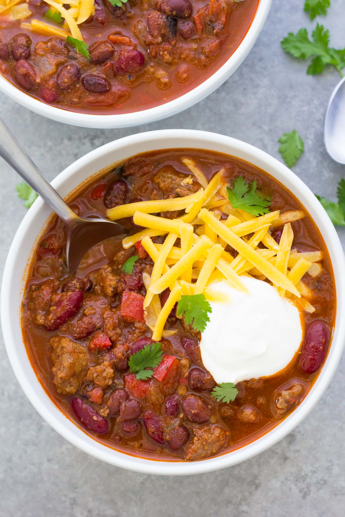 Instant pot chili served with cheese and sour cream.