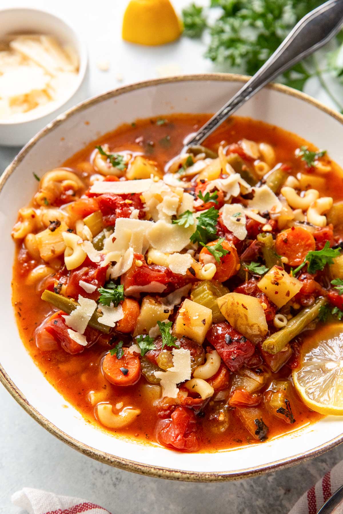 Instant pot minestrone soup served with lemon, parmesan and parsley.