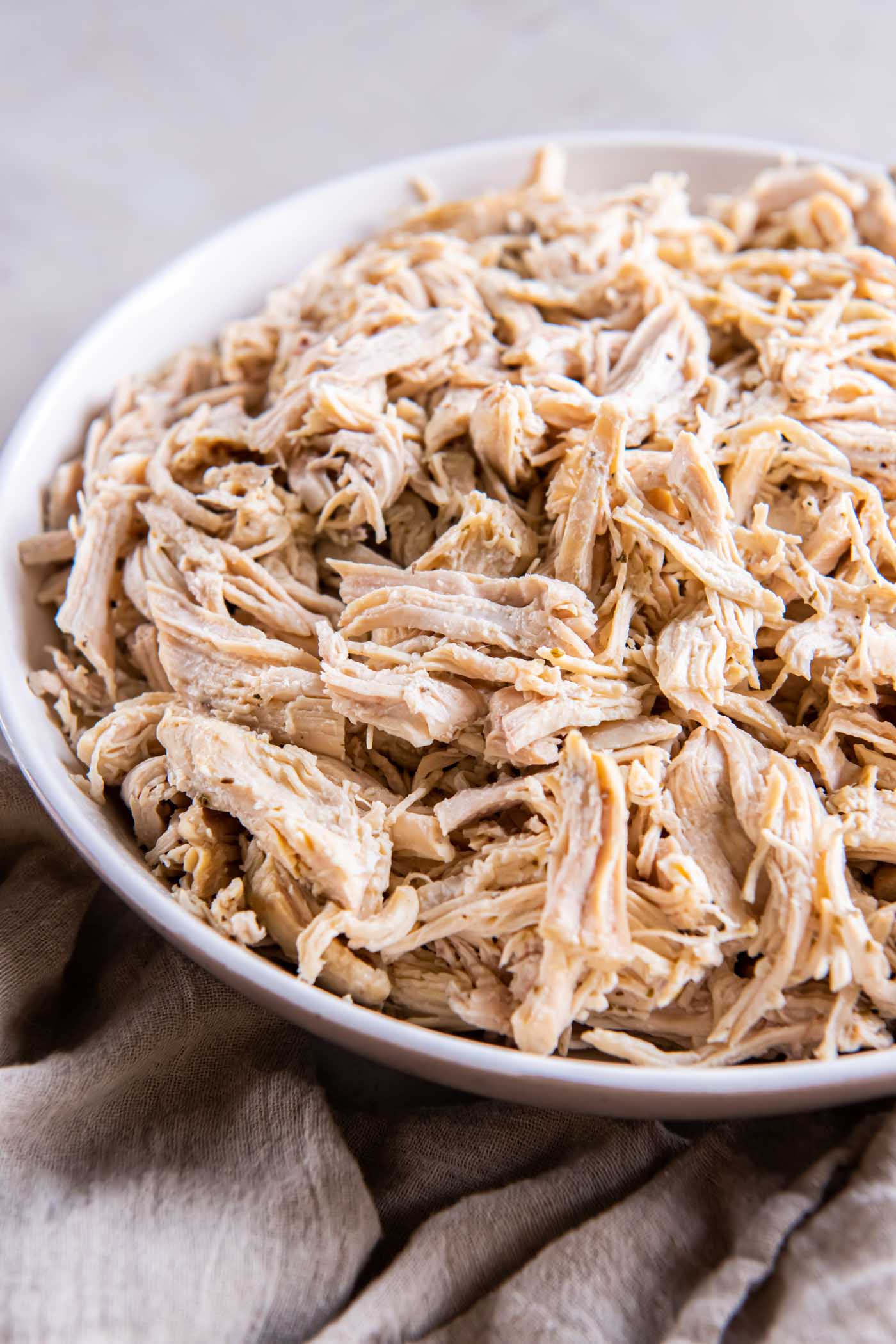 Close up of Instant Pot shredded chicken in a bowl.