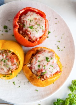 Three Instant Pot stuffed peppers on a white plate.