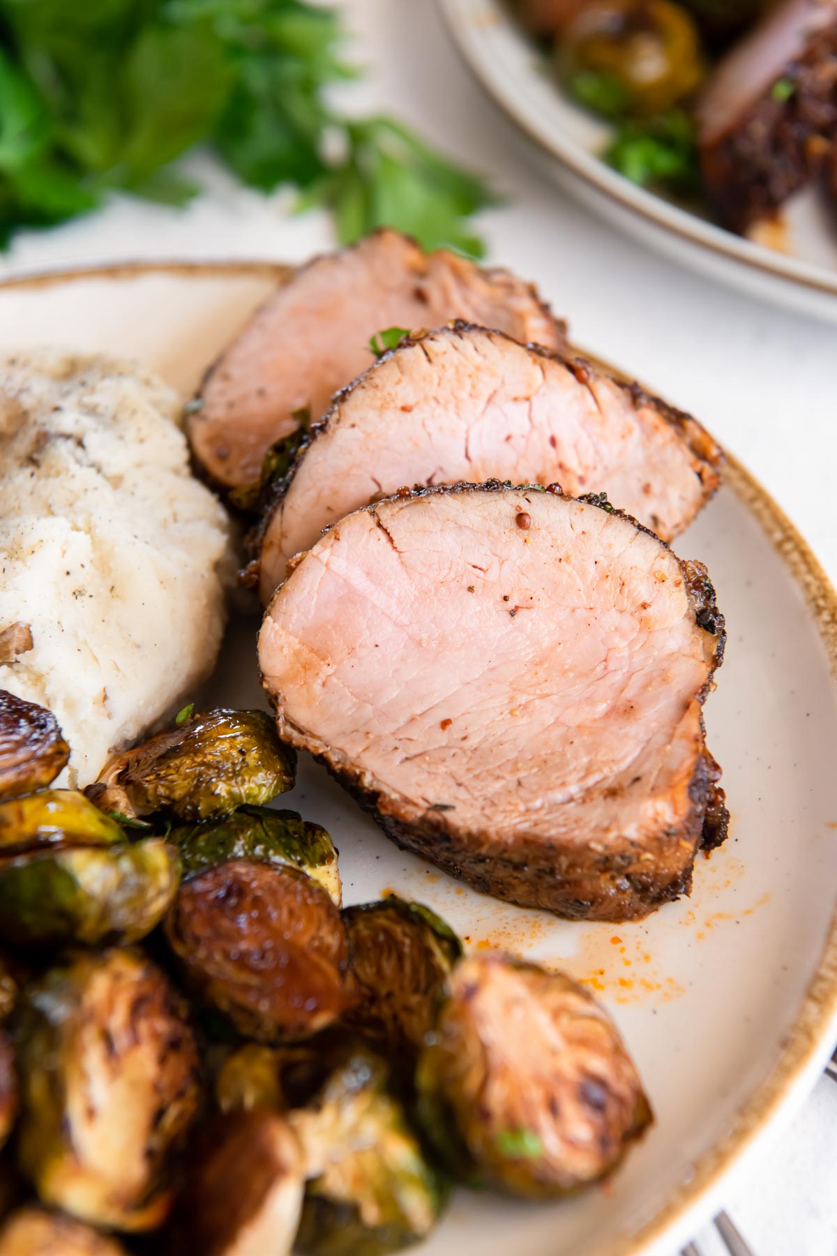 baked pork tenderloin served with mashed potatoes and brussels sprouts