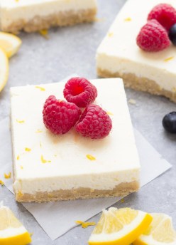 Ultra Creamy Lemon Greek Yogurt Cheesecake Bars! Our favorite easy dessert! These lighter cheesecake bars are made without cream cheese and have a whole wheat shortbread crust. Perfect for Easter or Mother's Day!