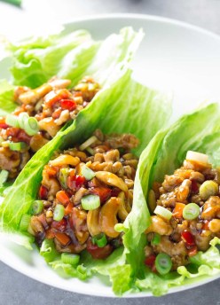 Cashew Chicken Lettuce Wraps with Orange-Ginger Sauce. A healthy dinner that's ready in just 30 minutes! You'll love these homemade asian lettuce wraps!