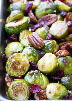 Balsamic Brussels Sprouts with maple balsamic glaze, pecans and garlic on a baking sheet.