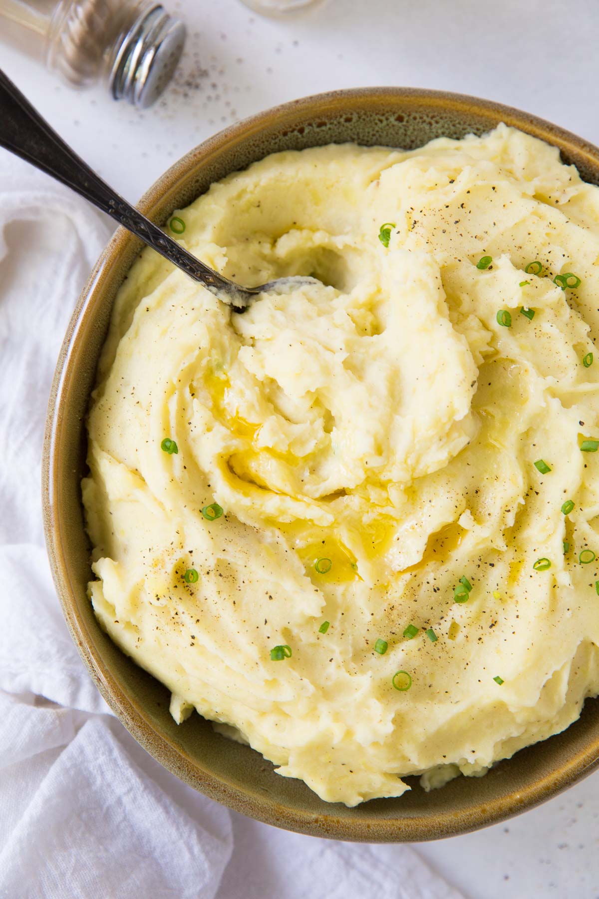 mashed potatoes in a bowl with a serving spoon