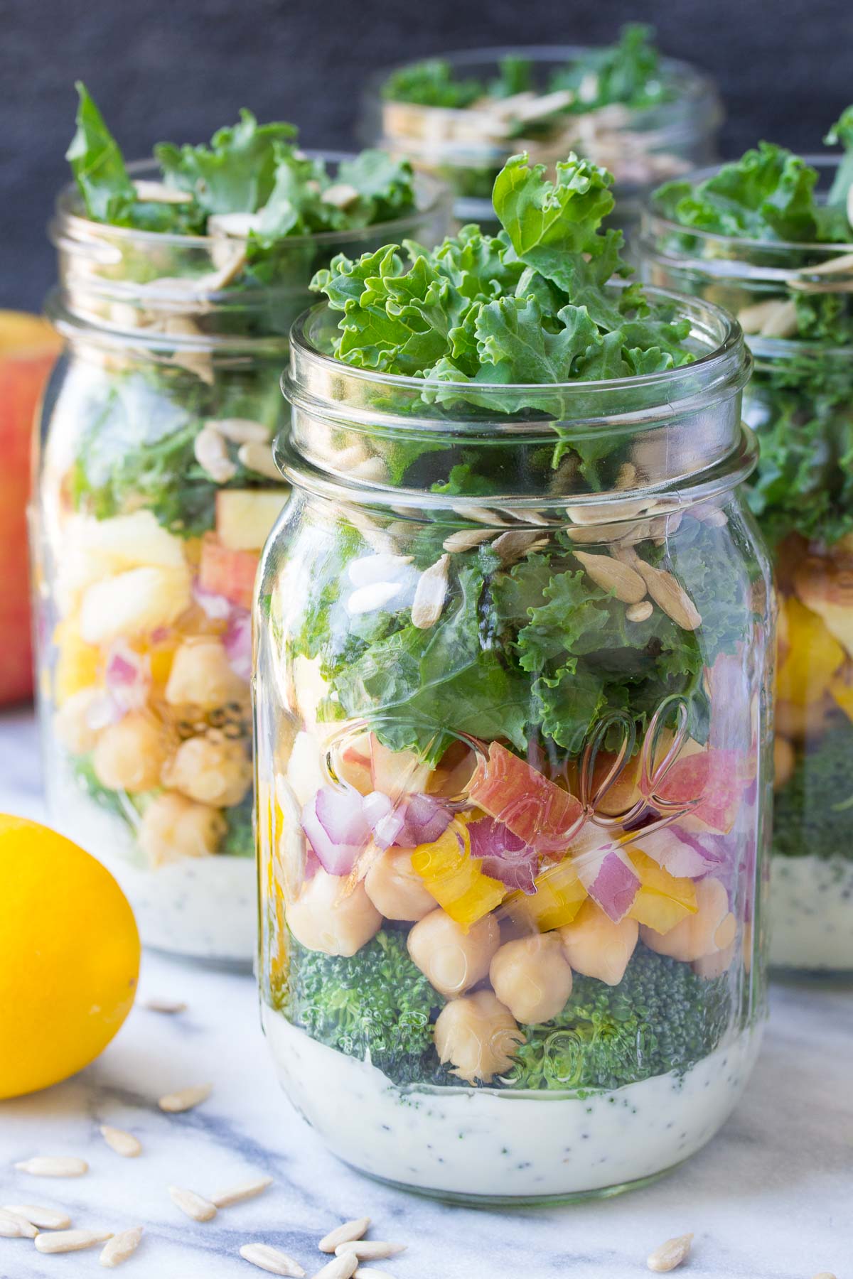 These easy vegetarian Mason Jar Broccoli Salads with Kale and Apple are a yummy make ahead lunch option! | www.kristineskitchenblog.com