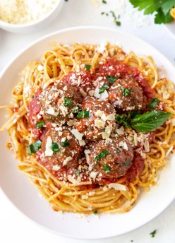 Meatballs served with spaghetti and marinara sauce.
