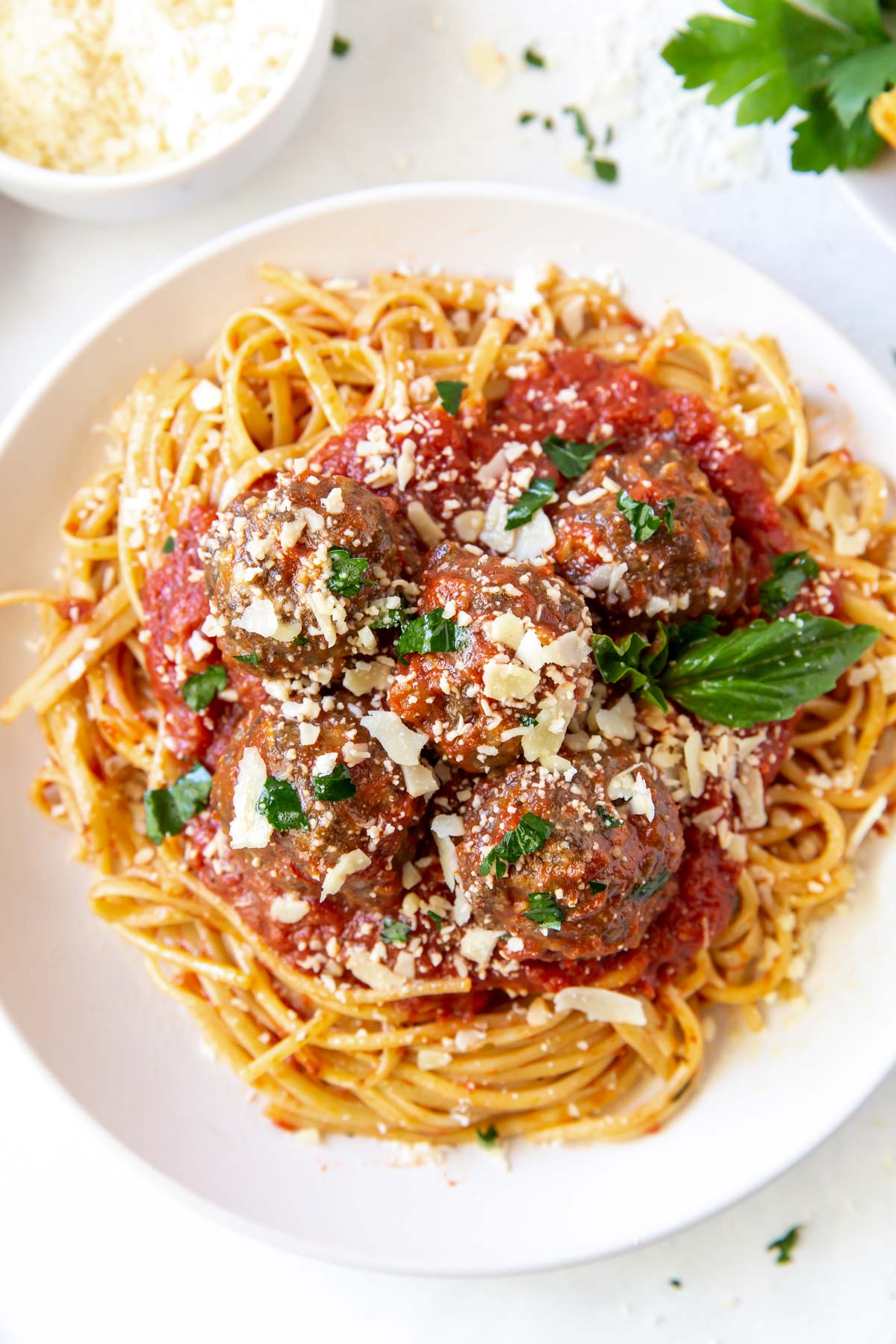 Meatballs served with spaghetti and marinara sauce.