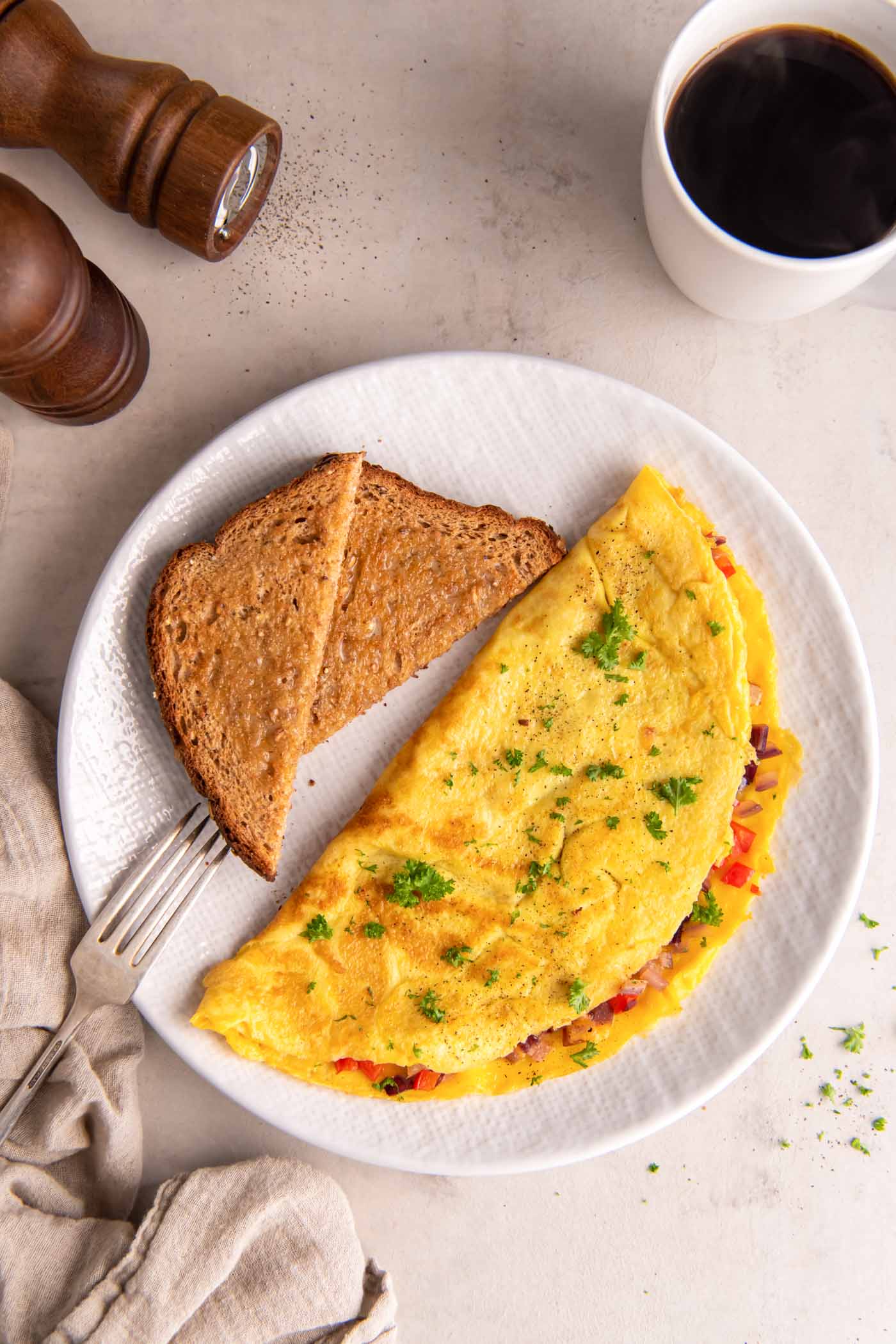 Omelet served with buttered toast and coffee.