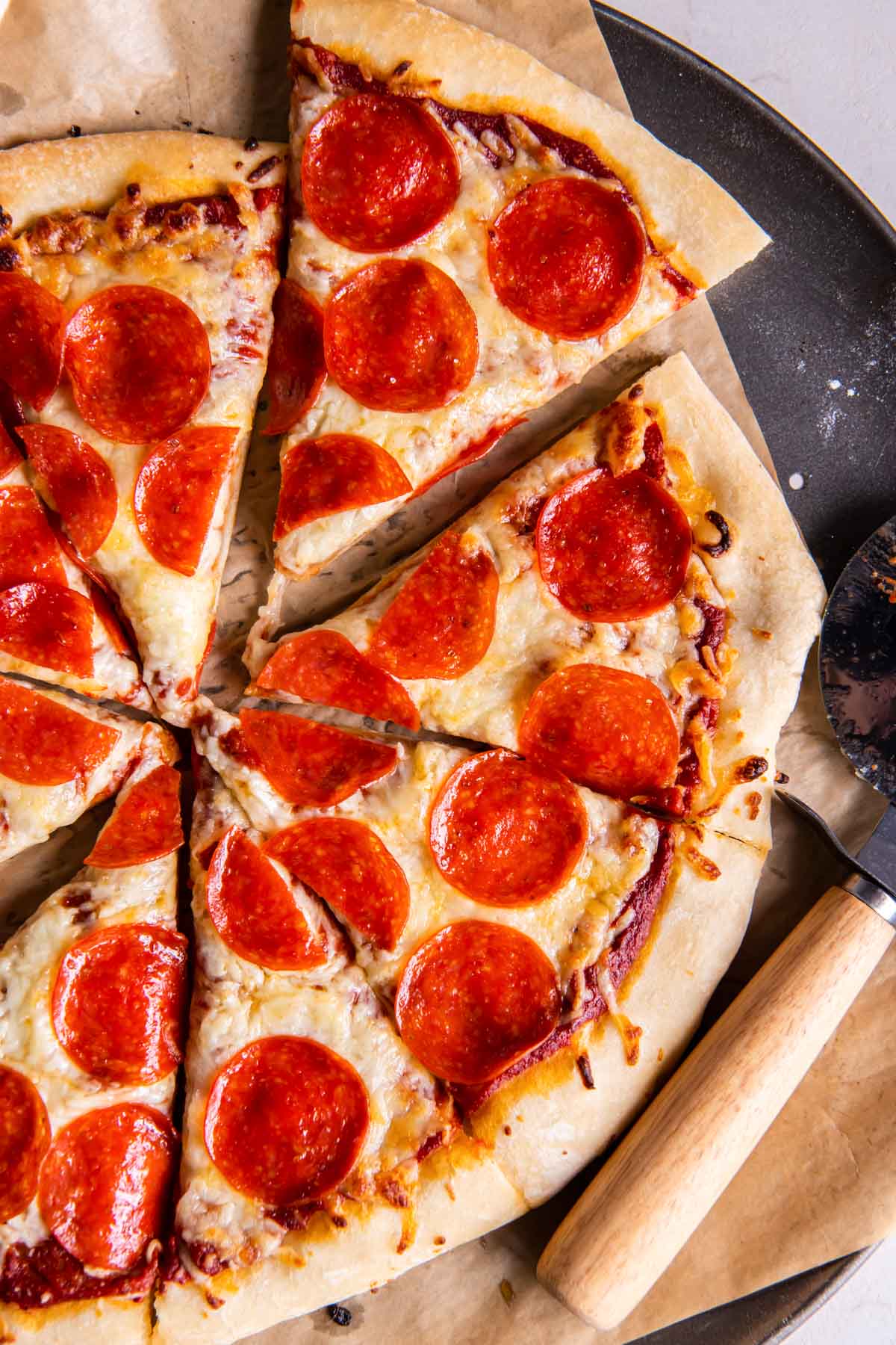 Sliced pepperoni pizza made with easy pizza dough recipe.