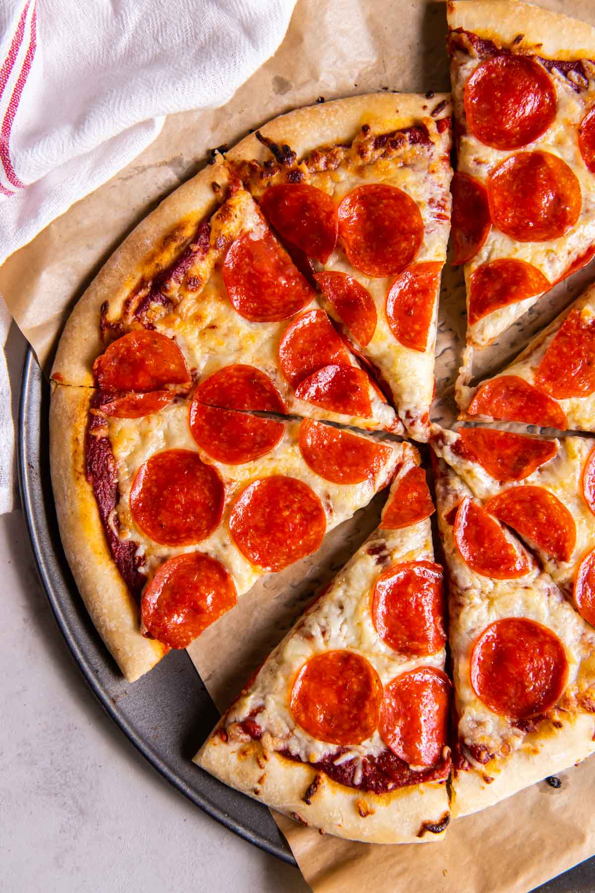 Sliced pepperoni pizza made with homemade pizza dough.