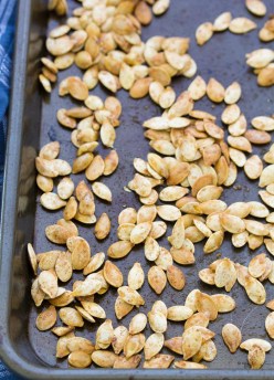 How to make perfectly crunchy roasted pumpkin seeds. An easy method for how to clean and make baked pumpkin seeds. Plus delicious ideas for seasoning your roasted pumpkin seeds, including sweet and salty and maple cinnamon!