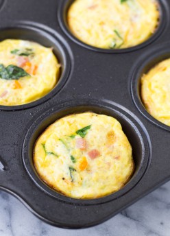 individual ham and cheese frittatas just out out of oven in muffin tray