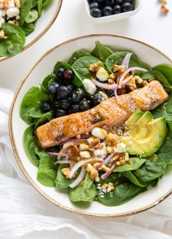 salmon salad with spinach, avocado, red onion, walnuts and goat cheese